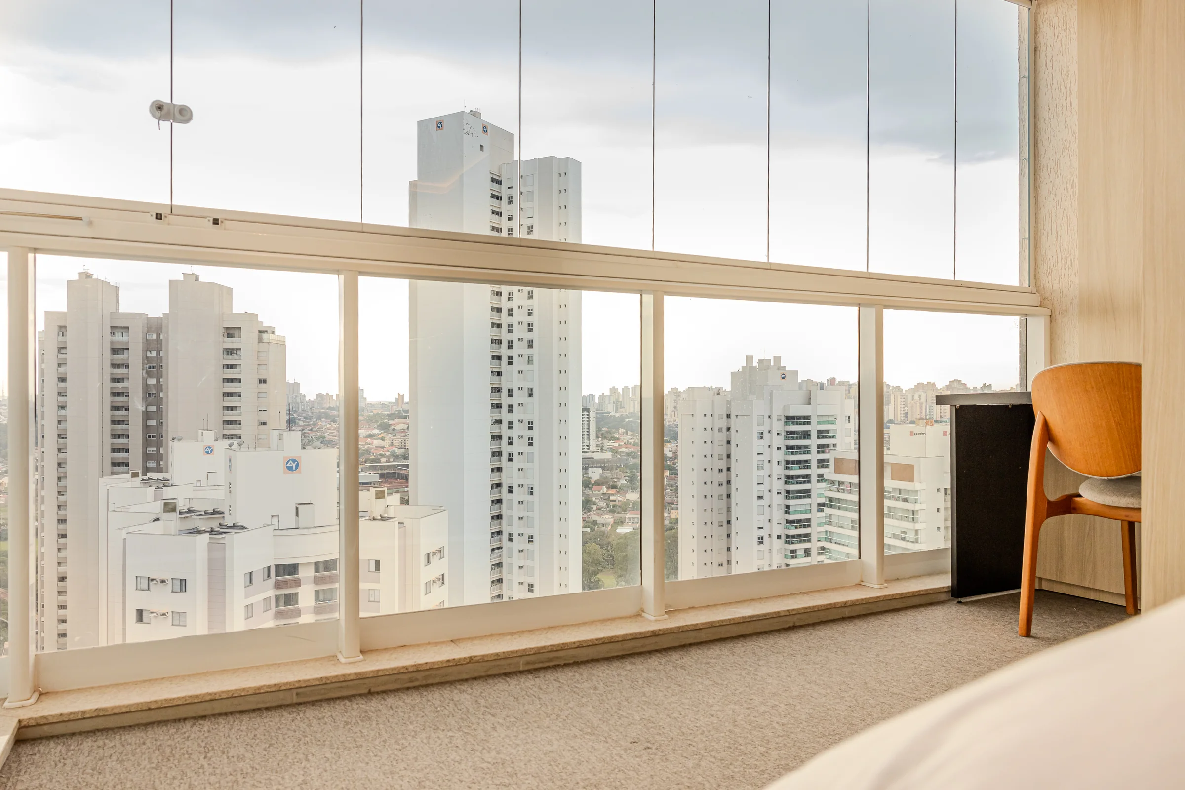 Janela ampla mostrando edifícios e o horizonte de Londrina.